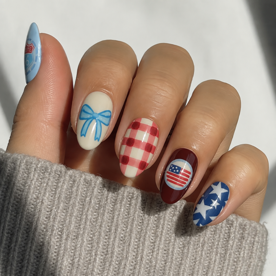 Americana Darling short almond press-on nails worn with a knit sweater